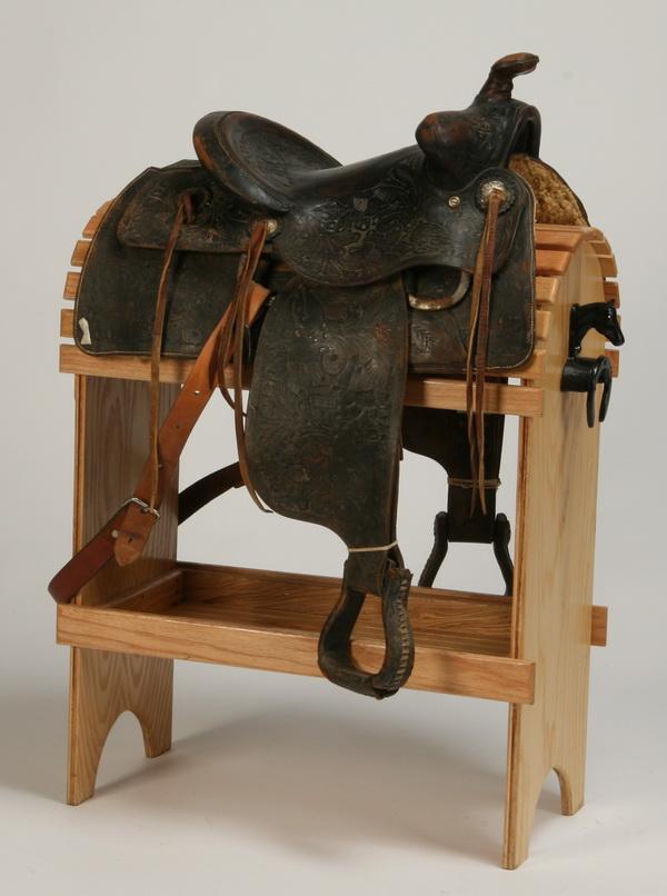 Western saddle by National Saddlery Co.: Western saddle in black tooled leather, maker marked National Saddlery Company, Oklahoma City. Display stand NOT included.