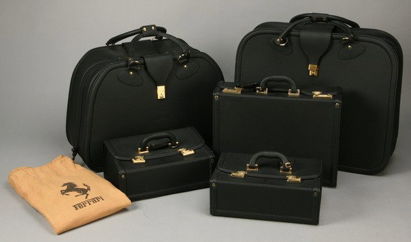 5-piece set of Ferrari 512 TR Italian luggage: 5-piece set of "Ferrari 512 TR" Italian leather luggage, the Ferrari logo embossed on each piece, with individual dust covers. Sizes: (1) 21"h x 24"w x 9"d; (2) 17"h x 24"w x 10"d; (3) briefcase 13"h 