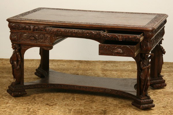 19th c. carved oak partner's desk: 19th century American carved oak partners' desk with relief carved foliate designs, the corners supported by four unique fully formed standing figures joined by a shaped stretcher, attributed to R. J.
