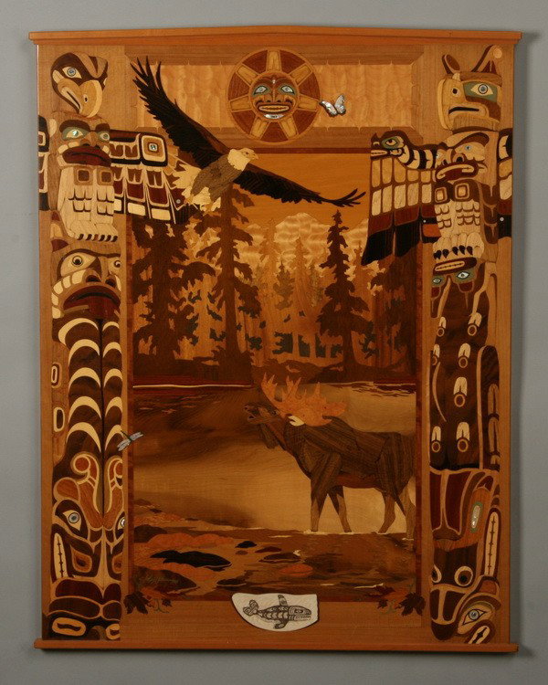 Marquetry inlaid decorative panel: Marquetry inlaid wood panel depicting the natural wonders of Alaska flanked by native totem poles, 39.5"h x 31"w.