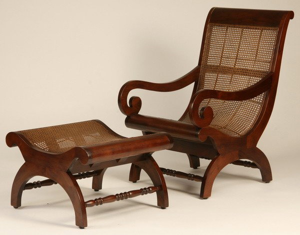 Carved teakwood and cane chair & ottoman: British colonial style carved teakwood and woven cane lounge chair and matching ottoman, chair 41"h x 24"w x 30"d; ottoman 17"h x 28"w x 24"d.