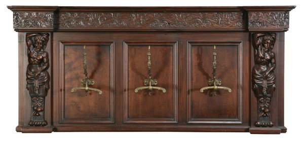 Carved walnut wall mounted coat rack: Carved walnut Renaissance Revival-style wall mounted coat rack with three antique coat hooks flanked by Atlas term figures, 29"h x 64"l.