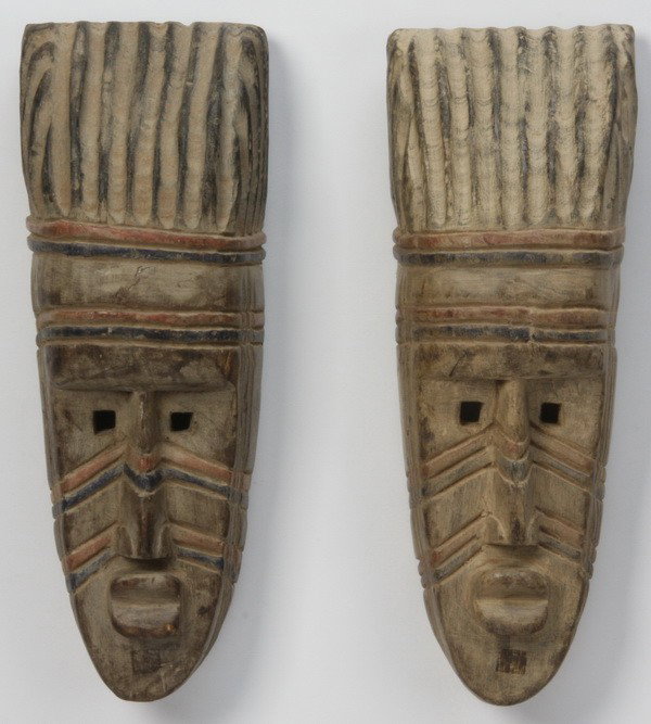 Pair of hand carved African masks: Pair of hand carved and decorated African masks from the Ashanti tribe in western Africa, 18"h x 7.75"w.