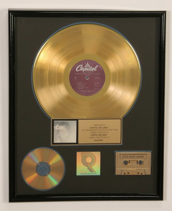 Framed commemorative John Lennon gold record: Framed commemorative gold record presented to Capitol Records for the sale of 500,000 copies of John Lennon's "Imagine" album, overall size 21"h x 17"w.