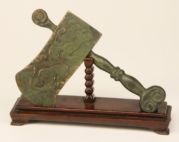 19th c. jade ceremonial axe: 19th century jade ceremonial axe with relief sculpted dragon on both sides of the axe head, on fitted display stand, overall size with stand 7"h x 9"w x 3"d.
