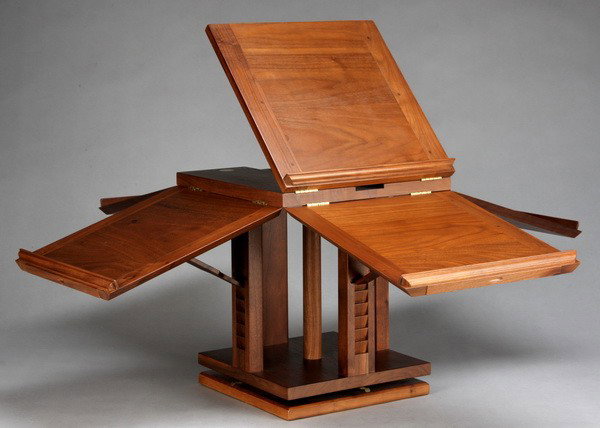 Revolving tabletop book stand: Revolving tabletop walnut book stand, designed to display 5 books simultaneously for reading, research or display, closed 15"h x 13" square.