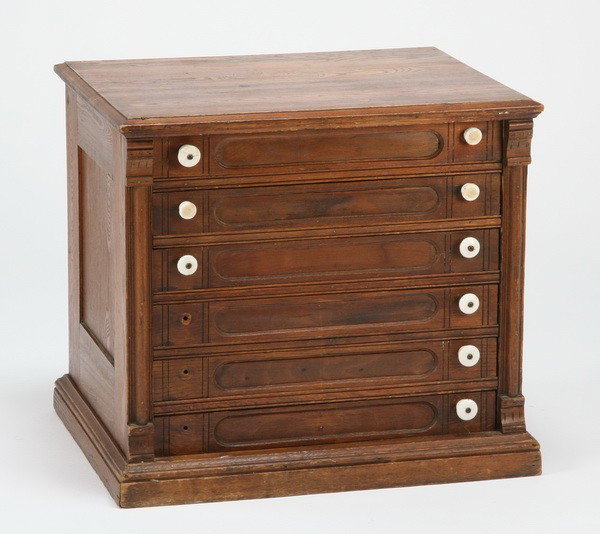 Early 20th c. oak spool cabinet: Early 20th century American oak countertop spool cabinet with porcelain knobs and 6 storage drawers, 36.5"h x 41.75"w x 20.5"d.