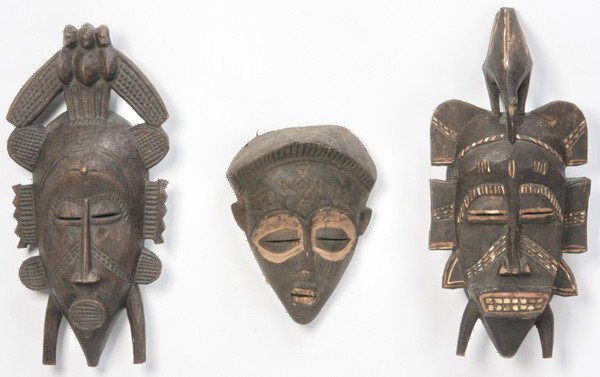 Group of three hand carved African masks: Group of three hand carved and decorated African masks from the Senufo tribe, (1) 17"h x 8"w; (1) 10"h x 7.5"w; (1) 17"h x 7.5"w.