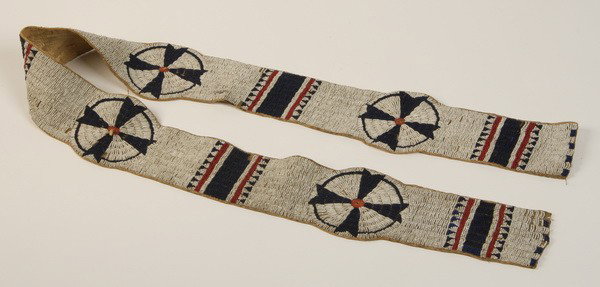 19th c. Sioux Indian beaded blanket strip: Late 19th century Sioux Indian finely beaded blanket strip sinew sewn and lane stitched with red, white and blue beads, with four rosettes alternating with rectangular stripes, 58"l x 4.5"w.