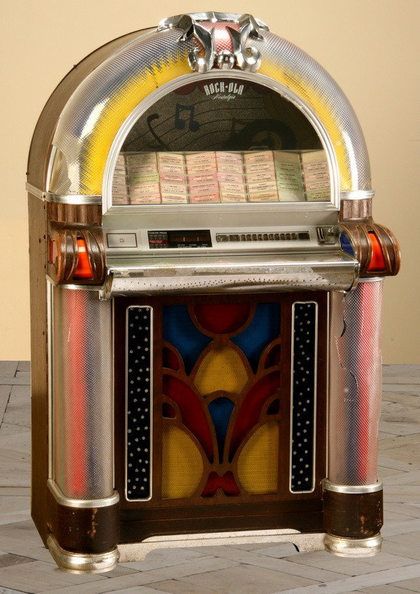 Rock-ola Model 1000 jukebox: Rock-ola Model 1000 jukebox, damages to the plastic surround, sold as is, 60"h x 36"w x 30"d.