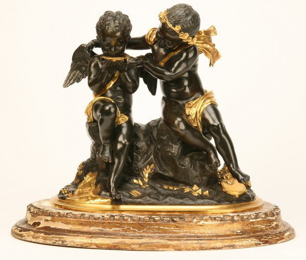 Early 20th c. bronze figural sculpture: Early 20th century patinated and gilt bronze figural sculpture on giltwood base depicting a pair of putti sharing a drink from a seashell, 15"h x 18"l x 7"w.