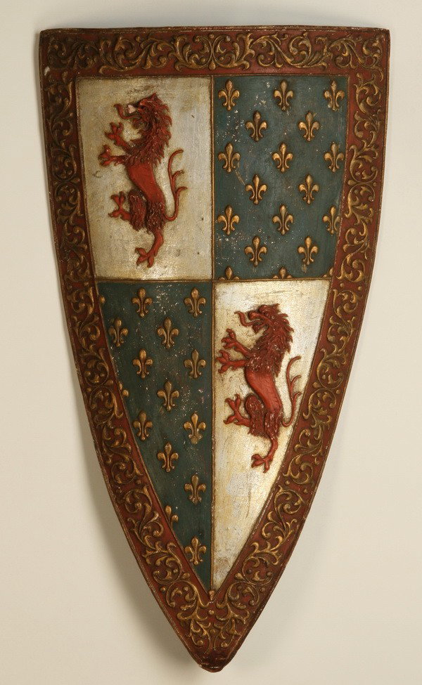 Pair of 20th c. decorative shields: Pair of 20th century decorative shields of composition material, bearing the lion insignia of Francois I (King of France from 1515-1547), with fleur de lys accents, 40"h x 24"w and 35"h x 22"w.