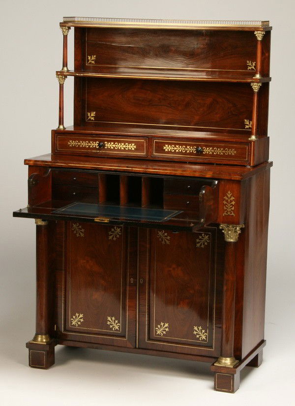 19th c. English Regency inlaid desk: Early 19th century English Regency brass inlaid rosewood two-part drop front secretary, with upper display shelves over two storage drawers, a drop front writing surface with inset gold tooled blue le