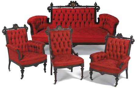19th c. American carved walnut parlor set: 19th century American Renaissance Revival carved black walnut 4-piece parlor set upholstered in tufted scarlet damask, each with a bronze medallion at the center of the crestrail. Set includes sofa, s