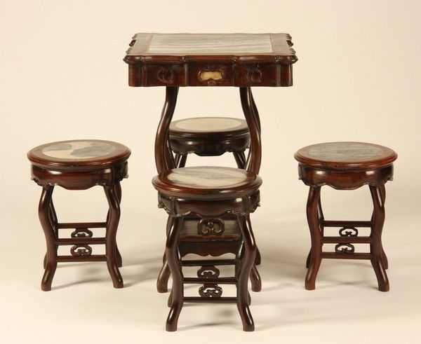 (5) Piece 20th c. Chinese tea table w/stools: 20th century 5-piece Chinese carved teakwood tea table and stools, each with an inset marble top; table 31.5"h x 21" square; stools 17"h x 13.5" diameter.