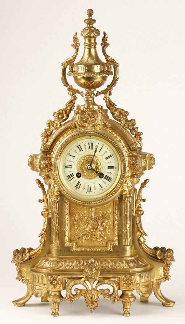 19th c. French dore' bronze clock: 19th century French Louis XVI style dore' bronze clock, the clock face surmounted by a lidded urn issuing floral garlands, the clock mechanism maker marked "Japy Freres, #14800-7-7, 20"h x 11"w x 5"d.