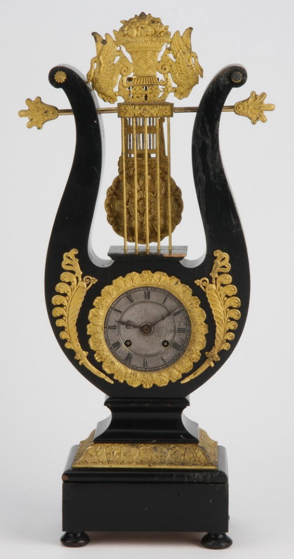 19th c. French lyre form bronze clock: Late 19th century French Empire clock in the form of a lyre with finely chased dore' bronze surmounts, 21"h x 8"w x 4.5"d.
