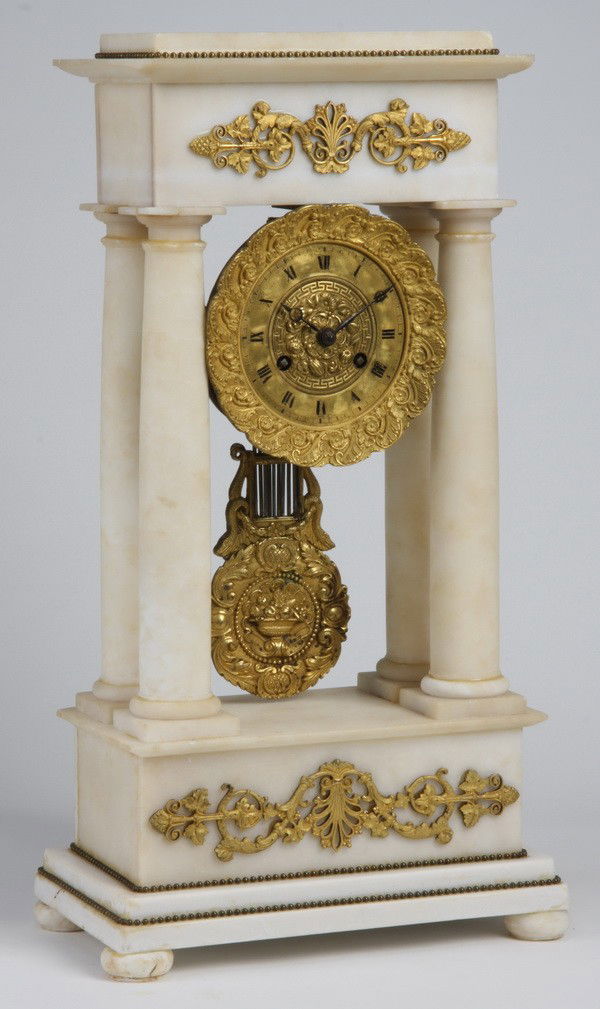 19th c. French alabaster and bronze clock: Mid 19th century French Empire alabaster clock with dore' bronze ormolu, featuring an extravagantly chased gilt bronze pendulum and clock face surround, 19"h x 10"w x 6"d.
