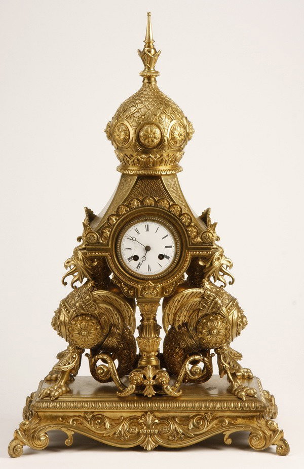 19th c. French dore' bronze figural clock: 19th century Napoleon III dore' bronze figural clock, featuring a Russian onion dome inspired steeple supported by opposing armor clad winged chimera, all resting on a rectangular plinth with scallope