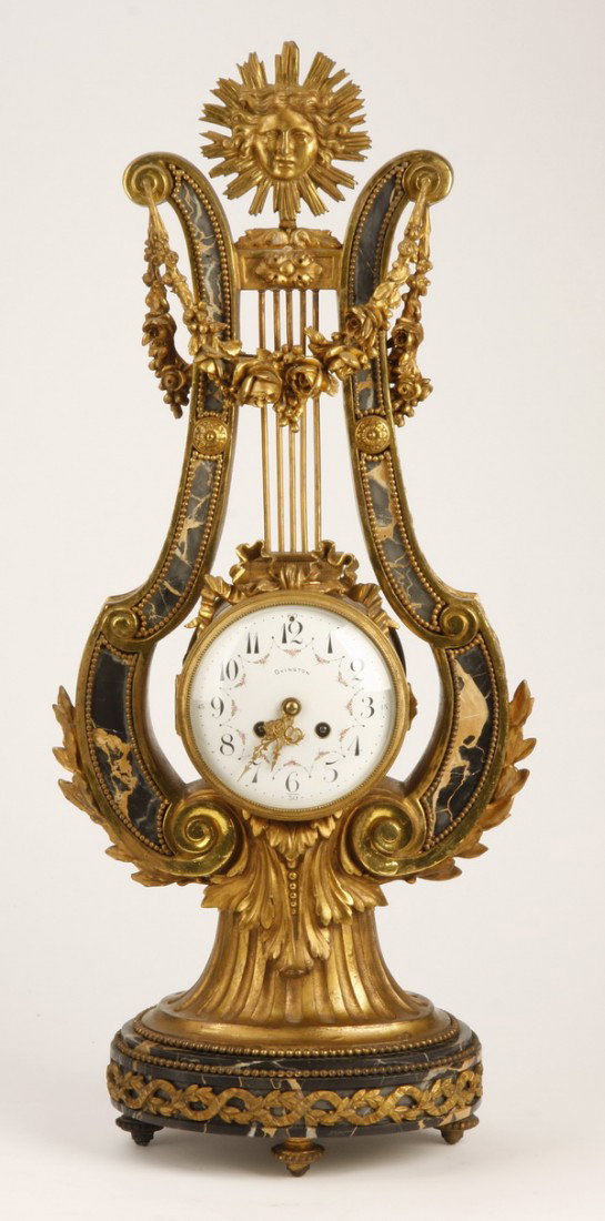 19th c. French bronze and marble clock: Late 19th century French dore' bronze mounted Portoro marble clock in the form of a lyre with a sunburst shaped finial, the porcelain clock face maker marked "Ovingtoin, France", the clock mechanism m