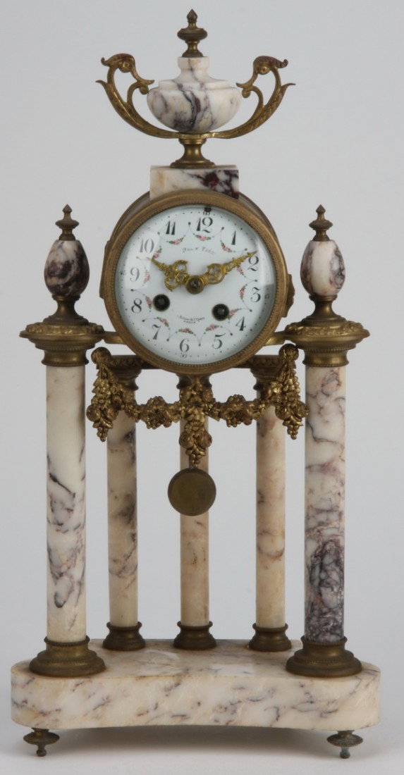 19th c. marble and dore' bronze clock: 19th century French Regency marble and dore' bronze clock, the clock face surmounted by an urn shaped finial, supported by columns entwined with grapevines, the clock mechanism maker marked "Rolf Frer