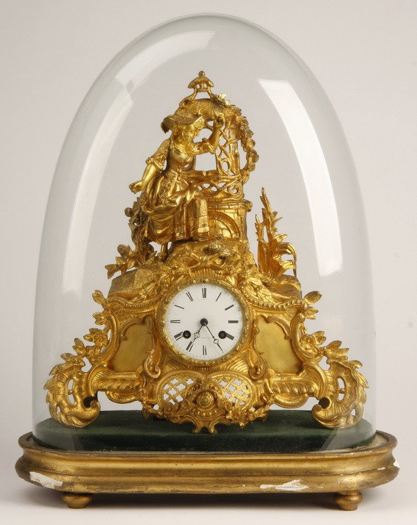 19th c. German dore' bronze figural clock: 19th century German Rococo style gilt metal and dore' bronze figural clock featuring a standing maiden feeding birds in a garden setting with a wishing well in the background, the clock mechanism make