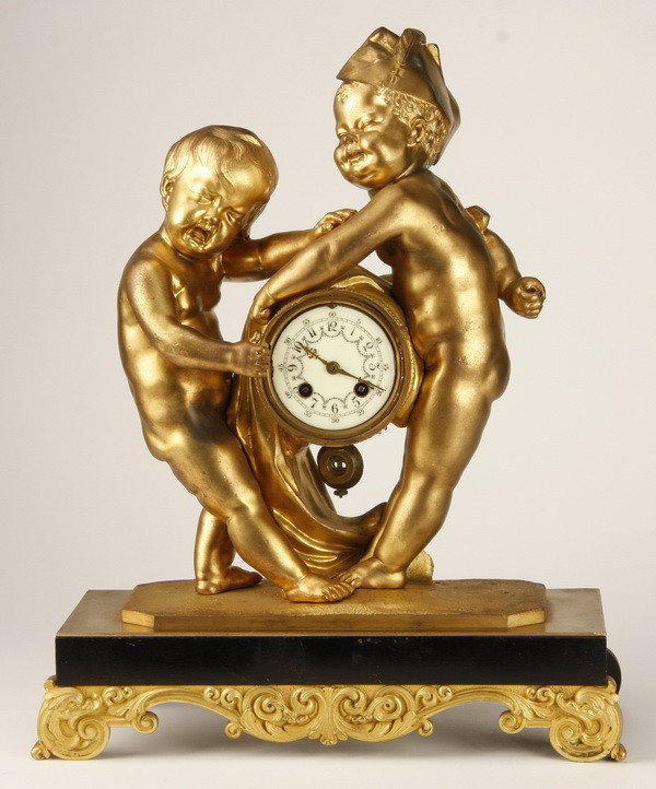 19th c. French dore' bronze figural clock: 19th century French Louis XV style dore' bronze figural clock depicting a pair of standing putti tugging on the clock,