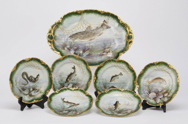 7-piece Limoges fish service, maker marked: Early 20th century hand decorated 7-piece Limoges fish service, each plate with a unique underwater scene and hand applied gold gilt edge, maker marked Haviland & Co., France; platter: 17.5"l x 12"w; 