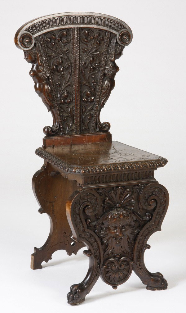Early 19th c. carved Venetian hall chair: Early to mid 19th century Venetian carved walnut hall chair, features a relief carved foliate backrest flanked by maiden term figures, with incised seat, and relief carved front panel with central Gre