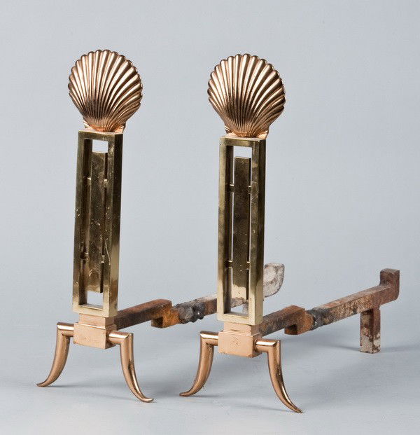 (2) 20th c. Art Deco andirons: Pair of early to mid 20th century Art Deco bronze and copper wash over bronze andirons with clam shell finial and splayed feet, 16.25"h x 6.5"w x 16"d.