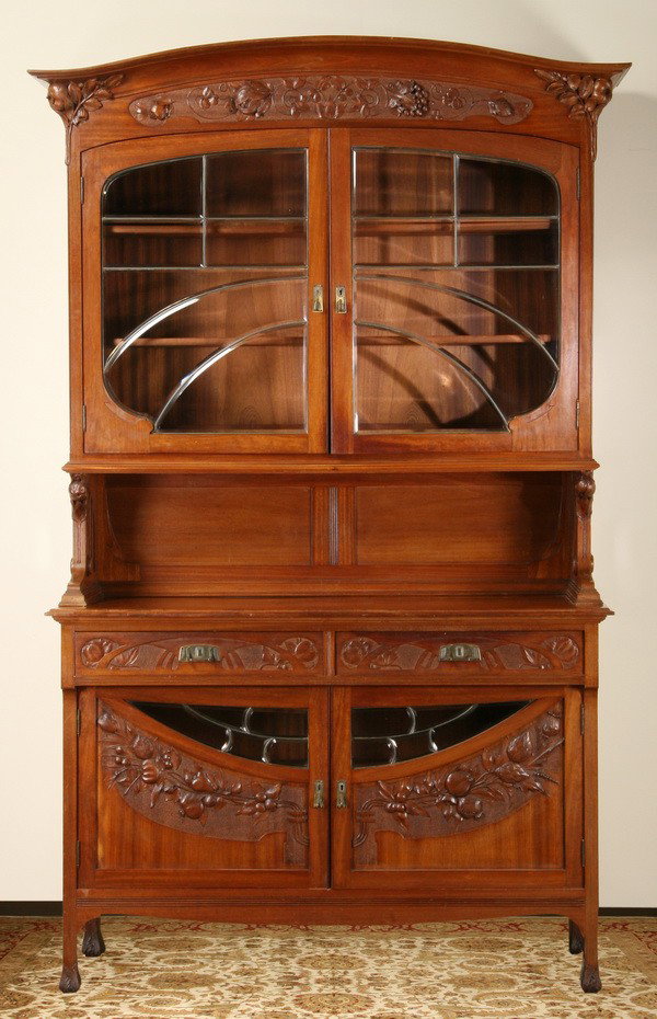 19th c. French Art Nouveau vitrine: 19th century French Art Nouveau walnut vitrine, with flared cornice supported by carved pomegranates, over a relief carved frieze of grapes and pomegranates surmounting leaded and beveled glass upper 