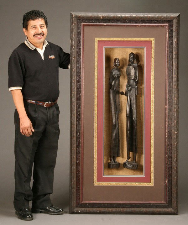 Oversized shadowbox with carved ebony figures: Oversized shadowbox with two hand carved ebony figures, overall size including frame 65"h x 35"w.