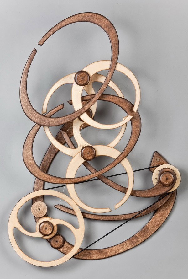Limited edition kinetic wood sculpture: Limited edition spring driven kinetic wood sculpture titled "Fusion", by Connecticut artist David C. Roy, when activated the sculpture has a continual run time of approximately 4 hours, 36"h x 29"w x 
