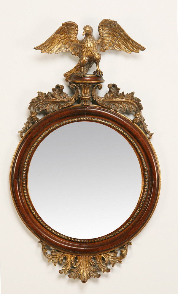 American Federal style carved mahogany mirror: American Federal-style parcel gilt carved mahogany mirror with carved eagle at the crest, 38"h x 22" diam.