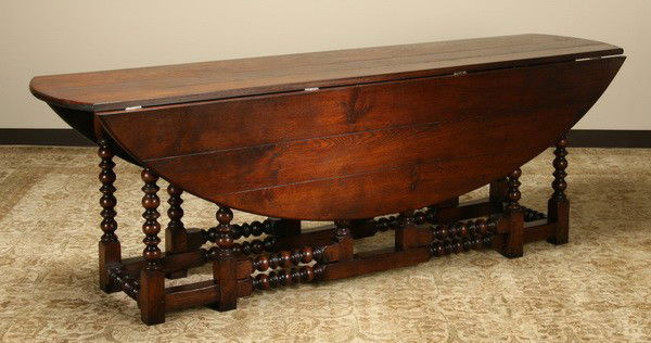 English drop leaf oak dining table: English quarter sawn oak drop leaf dining table with turned legs, 31"h x 90"l x 59"w when open.