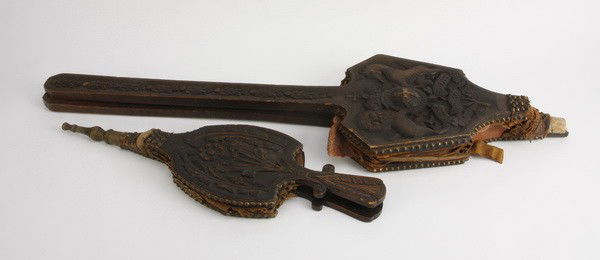 (2) Early 19th c. fireplace bellows: Two early 19th century decorative fireplace bellows with carved oak sides (both with damaged leather), long 43"l x 11.5"w; short 27"l x 8"w with bronze tip.