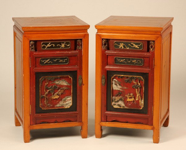 (2) Early 20th c. Chinese nightstands: Pair of early 20th century Chinese nightstands, each with one drawer over single door storage, relief carved and polychrome decorated, 31"h x 18"w x 17.5"d.