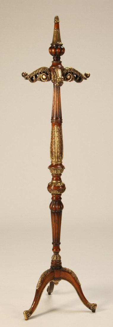 Carved and parcel gilt mahogany coat rack: Carved and parcel gilt mahogany coat and hat rack, the 3 arms and carved finial emanating from a central shaft on a tripod base, 74"h x 20" diam. at the base.