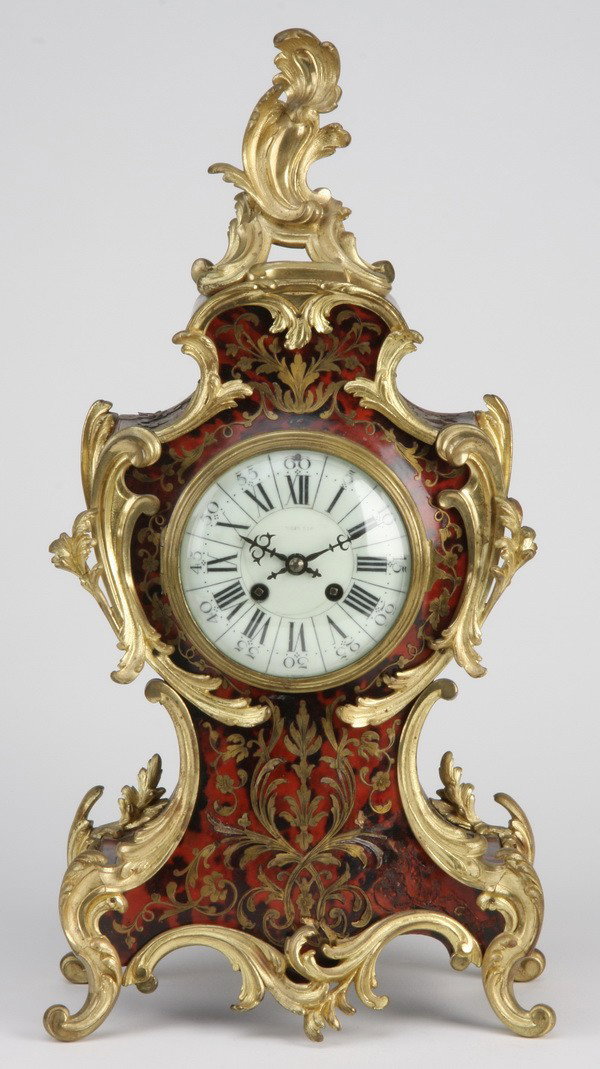 19th c. French boulle clock: Late 18th or early 19th century French Louis XV Boulle clock with brass & tortoiseshell inlays and dore' bronze surmounts, 20.5"h x 10.5"w x 6"d.
