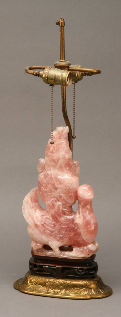 19th c. carved rose quartz figural lamp: 19th century figural lamp of carved rose quartz depicting a bird and covered urn raised on a pierce carved rosewood base, 24"h.