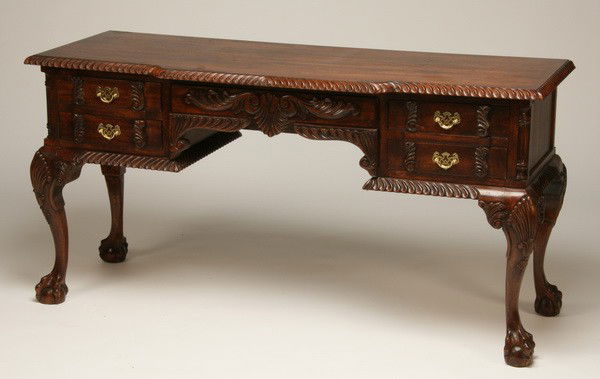 Carved mahogany credenza: Carved mahogany Chippendale-style credenza with gadrooned edge, concealed central drawer with relief carved foliate front, all raised on cabriole legs terminating in ball and claw feet, 30.5"h x 60"l
