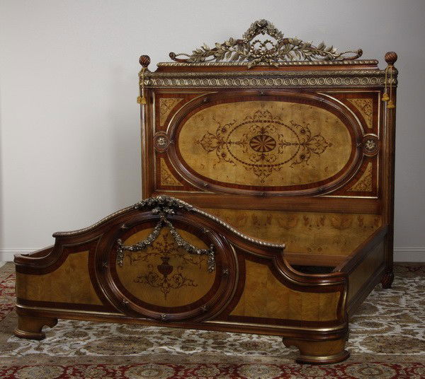 Carved and marquetry inlaid king size bed: Extravagantly carved and parcel gilt burled walnut king size bed, the headboard, footboard and side rails marquetry inlaid with flower filled urns and flowing arabesques; headboard 85"h x 85"w, overal