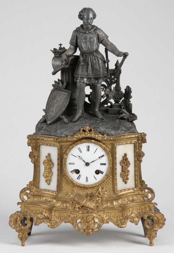 19th c. French bronze figural clock: 19th century French gold and silver over bronze figural clock depicting a standing knight in armor at the crest, 17.5"h x 12"w x 5"d.
