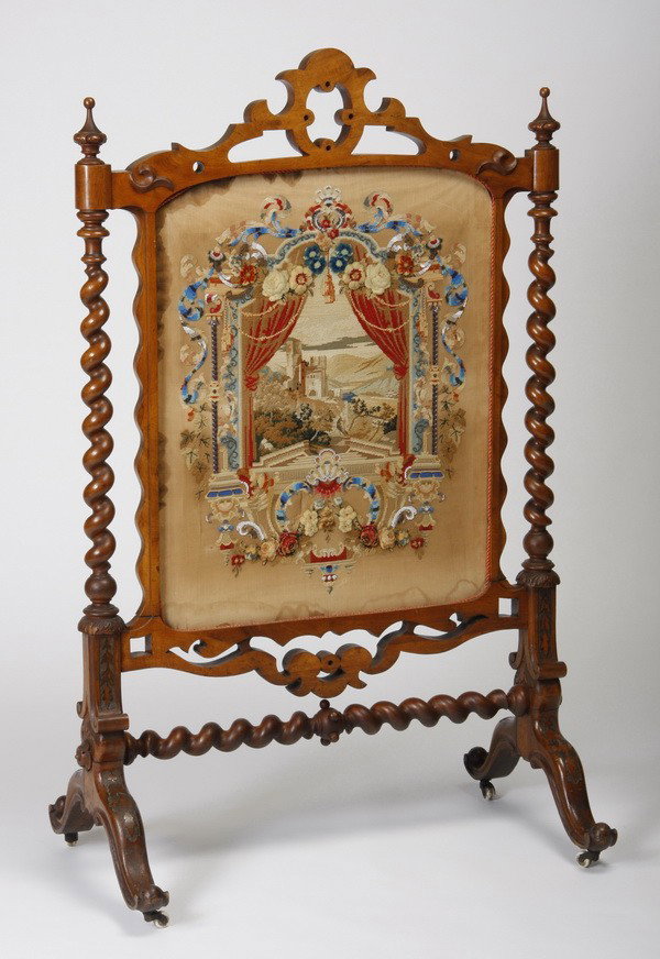 Oversized 19th c. English walnut fire screen: Oversized 19th century English walnut fire screen with central needlepoint panel depicting a castle in the countryside as viewed through an open window, with beading and metallic thread accents, suppo