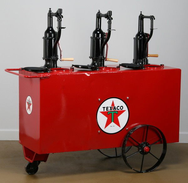 Rare triple compartment motor oil wagon: Rare triple compartment motor oil wheeled wagon with three hand cranked pumps, and the Texaco brand logo, 50"h x 48"l x 18"d.