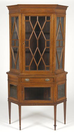 19th c. curio cabinet: 19th century Edwardian curio cabinet with individually mortised glass doors, decorated with pencil inlays of satinwood and yew wood, on a single drawer base cabinet surmounting a lower display case, a