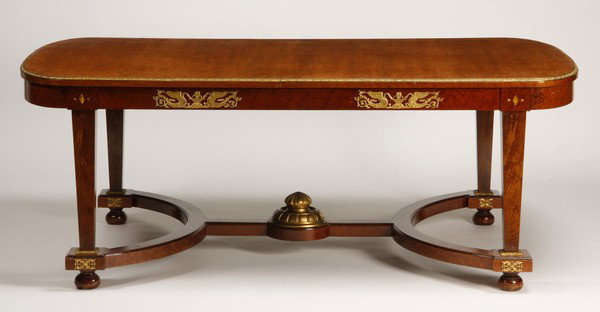 19th c. French Empire bronze mounted table: 19th century French Empire dining table features doré bronze mounts around the edges, and curved stylized H-stretcher base with large central bronze finial, 30.5"h x 80.5"l x 47.5"d.