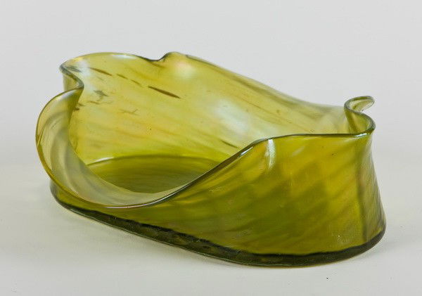 19th c. iridescent art glass bowl: Late 19th or early 20th century green iridescent art glass bowl in the manner of Loetz, mold-blown with hand worked details, 3.75"h x 11.25"l x 6.5"d at the base.