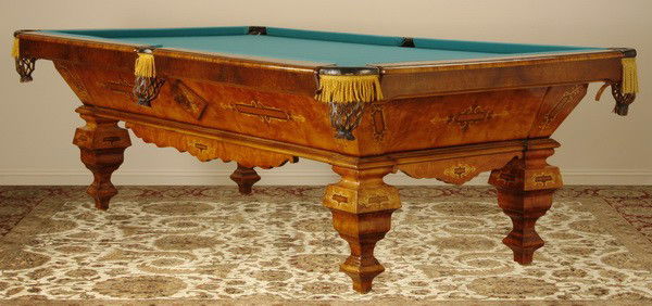 Marquetry inlaid regulation size pool table: 20th century American Renaissance Revival style marquetry inlaid regulation size pool table, 60"w x 108"l, with standing polished brass cue stick holder and 4 cue sticks.