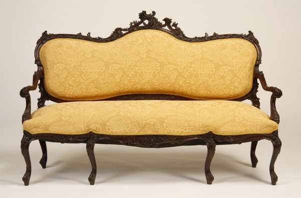 19th c. French carved oak settee: 19th century French Rococo-style carved oak settee with pierce carved and crested frame upholstered in golden damask, set on cabriole legs, 41"h x 62"w.